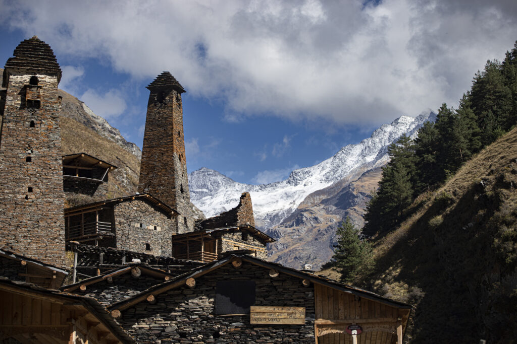 A Svan tower against snowy peaks
